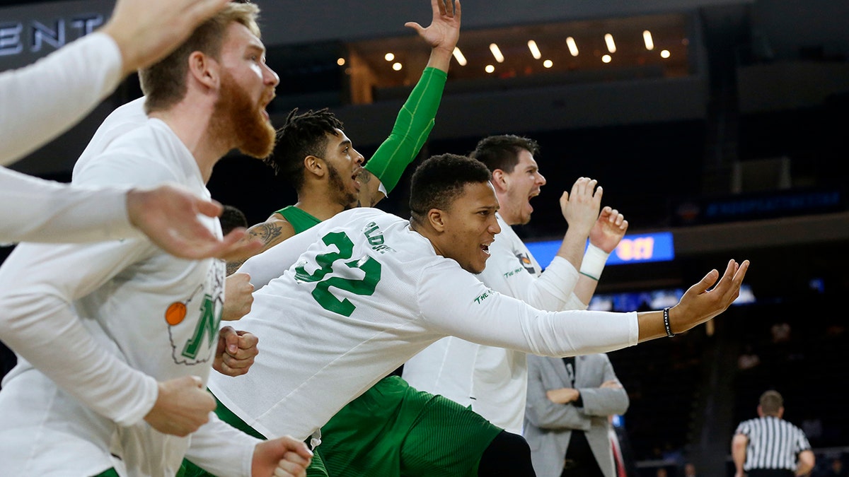 FILE - In this Saturday, March 10, 2018, file photo, then-Marshall guard Phil Bledsoe (32) and the Marshall bench react to a 3-point shot against Western Kentucky during the second half of the NCAA Conference USA basketball championship game in Frisco, Texas. (AP Photo/Michael Ainsworth, File)