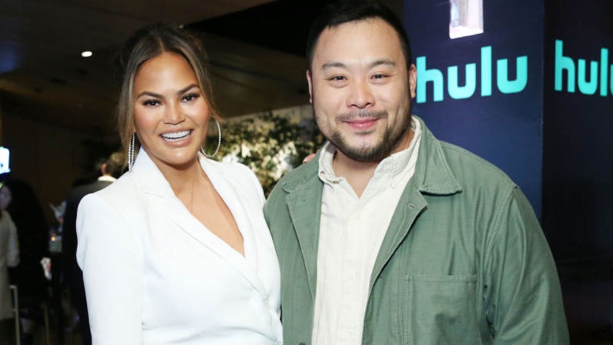 Chrissy Teigen and David Chang have announced a partnership with Hulu to produce and host food programming. One of the first projects they will work on will "revolve around the ways in which people express their love for friends and family by cooking and eating together," a release said. (Photo by Monica Schipper/Getty Images for Hulu)