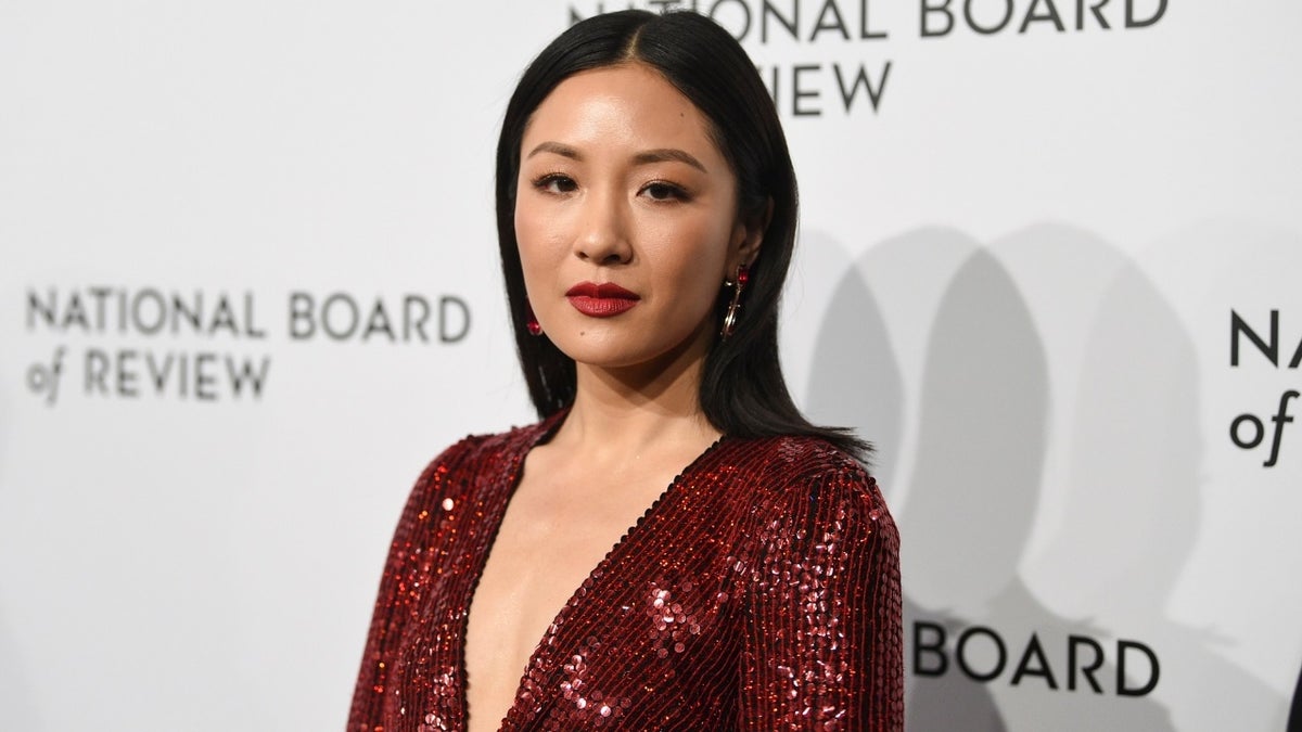 Constance Wu wearing a red dress on the red carpet at a gala in NYC
