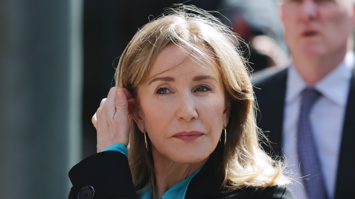FILE - In this April 3, 2019 file photo, actress Felicity Huffman arrives at federal court in Boston to face charges in a nationwide college admissions bribery scandal. On Monday, May 13, 2019, Huffman is expected to plead guilty to charges that she took part in the cheating scam. (AP Photo/Charles Krupa, File)