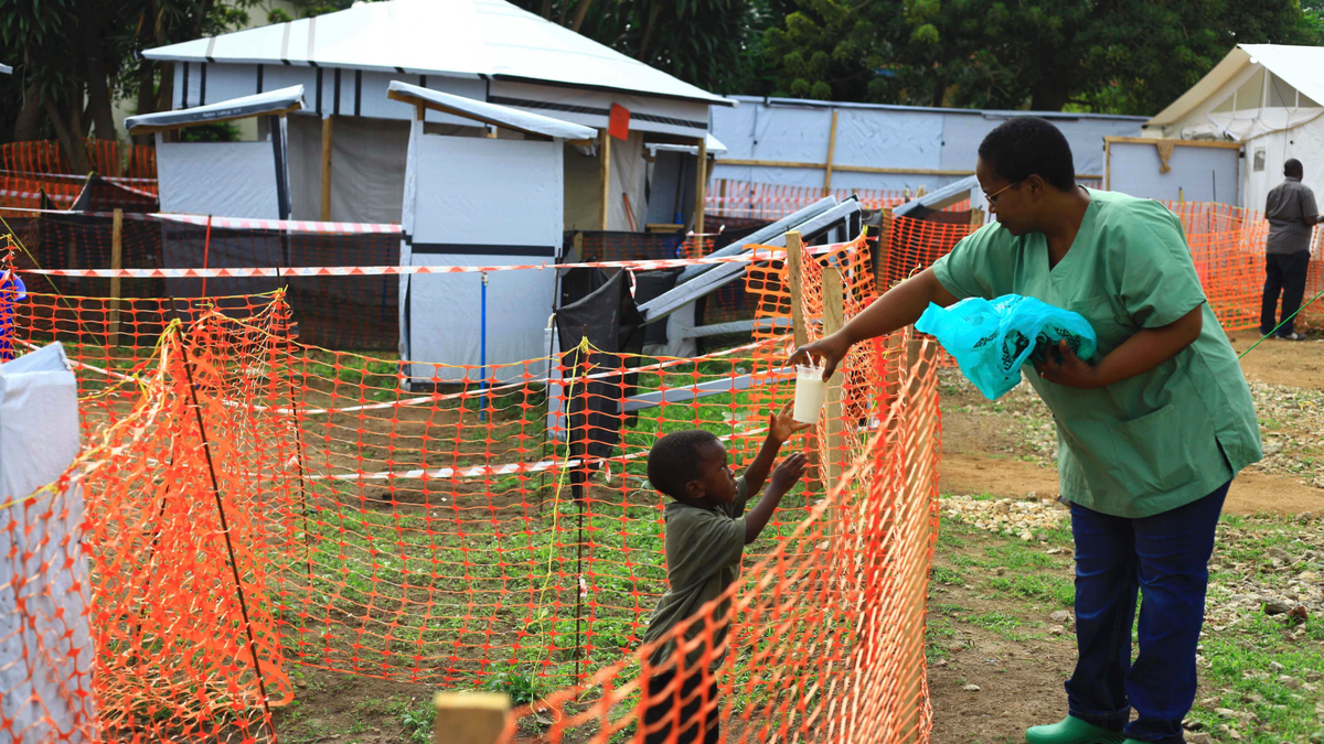 In this Sunday, Sept. 9, 2018 file photo, a health worker feeds a boy suspected of having the Ebola virus at an Ebola treatment center in Beni, Eastern Congo.