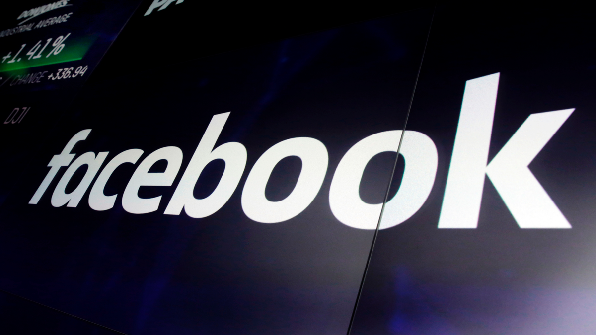 FILE - In this Thursday, March 29, 2018, file photo, the logo for Facebook appears on screens at the Nasdaq MarketSite, in New York's Times Square. (AP Photo/Richard Drew, File)