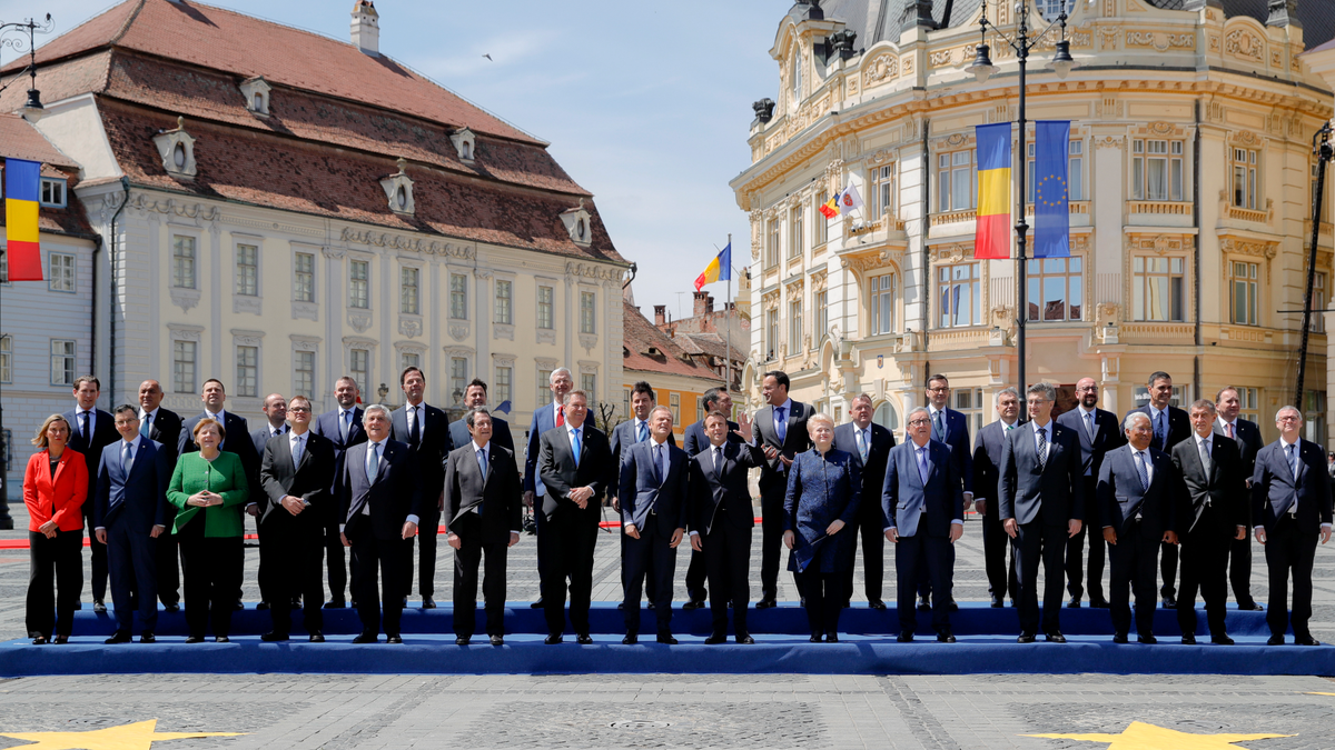 European Union leaders lined up and posing for a photo at a meeting in Romania 