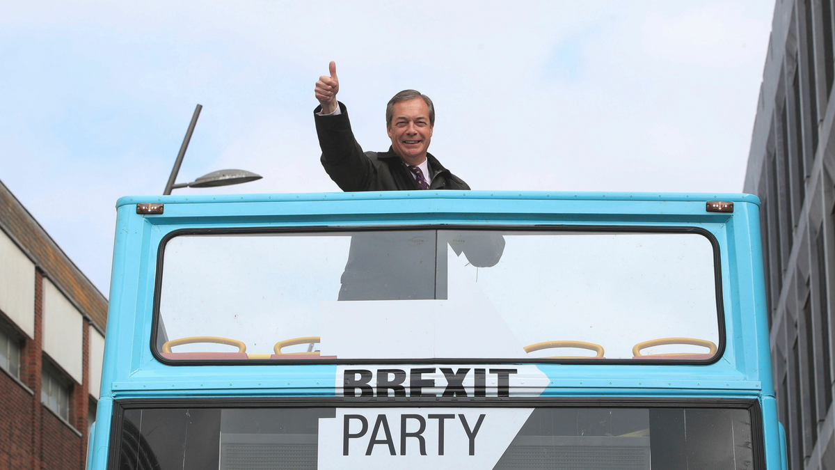 Brexit Party leader Nigel Farage gestures on an open-topped bus while on the European Election campaign trail in Sunderland, England, Saturday, May 11, 2019.