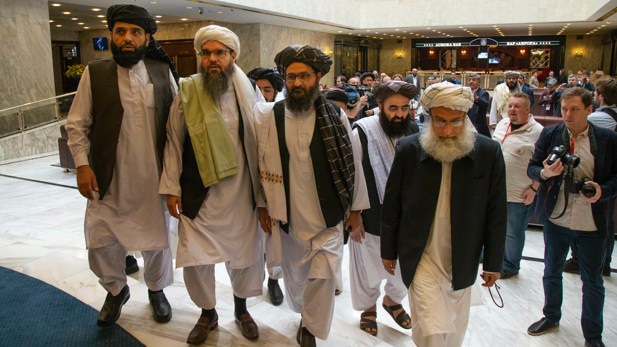 Mullah Abdul Ghani Baradar, the Taliban group's top political leader, third from left, arrives with other members of the Taliban delegation for talks in Moscow, Russia, Tuesday, May 28, 2019. Baradar and a team of 14 Taliban are in Moscow where they are scheduled to meet other Afghans including former President Hamid Karzai and some of the candidates in the presidential elections.