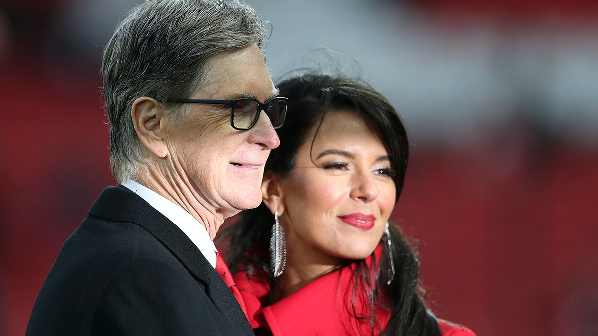 Liverpool FC owner John Henry and his wife Linda Pizzuti pose before the English Premier League soccer match between Liverpool and Huddersfield Town at Anfield Stadium, in Liverpool, England, Friday, April 26, 2019.(AP Photo/Jon Super)