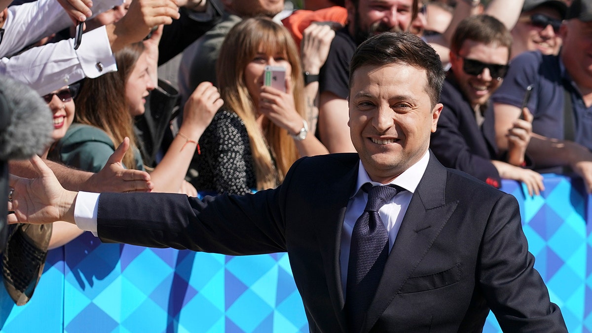 Ukrainian President-elect Volodymyr Zelenskiy greeds supporters before inauguration ceremony in Kiev, Ukraine, Monday, May 20, 2019. Zelenskiy overwhelming won the presidential election last month, beating incumbent Petro Poroshenko. (AP Photo/Efrem Lukatsky)