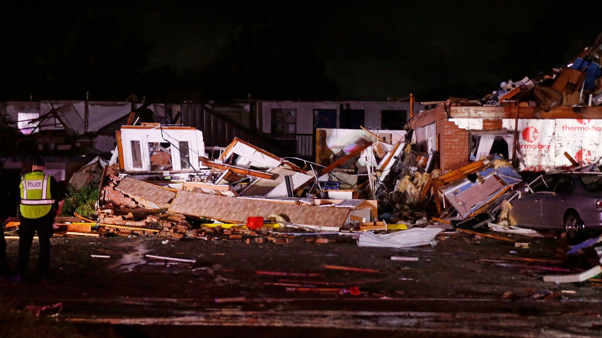 Police stand at the ruins of a hotel in El Reno, Okla., Sunday, May 26, 2019, following a tornado touchdown late Saturday night.