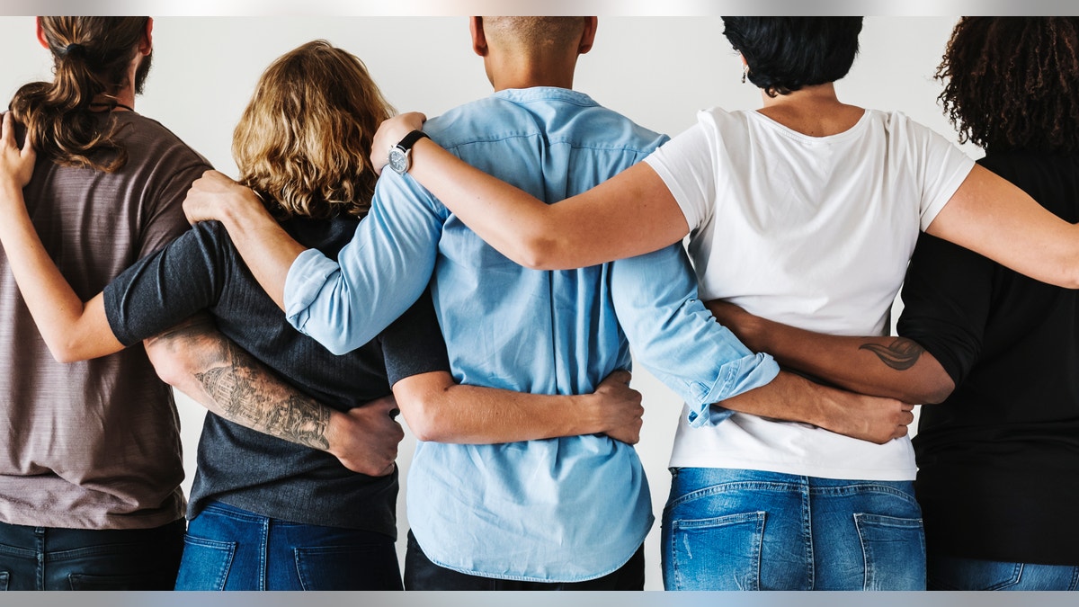 A group of friends with their arms around each other