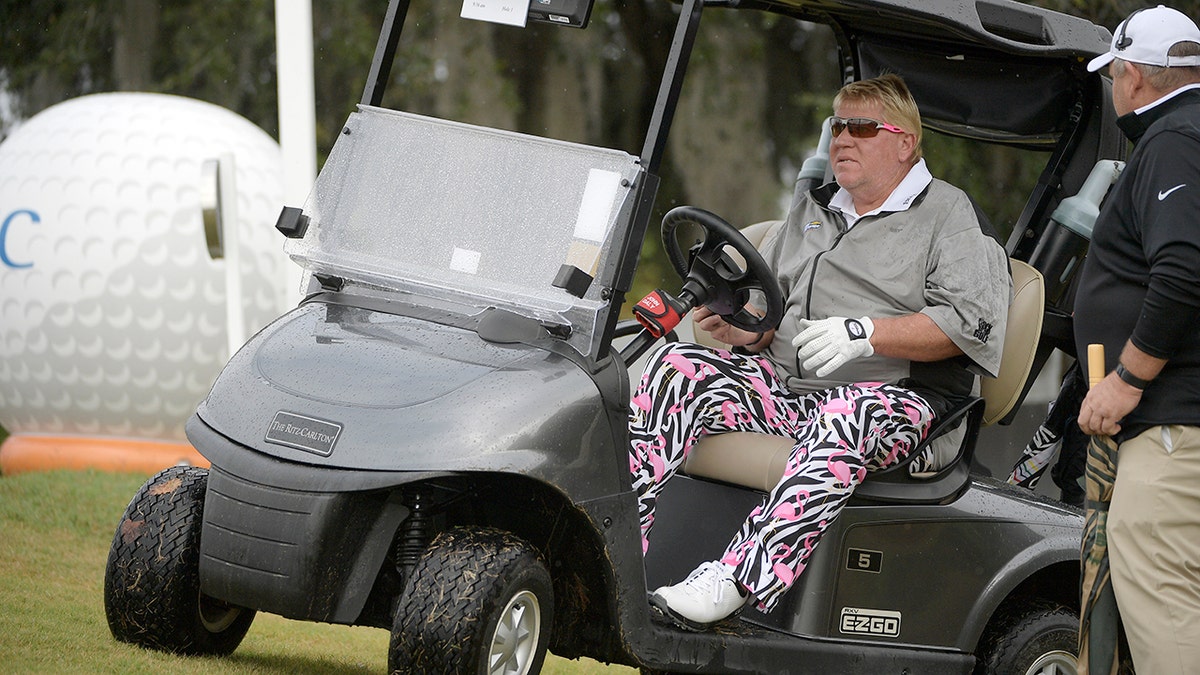 In this Dec. 15, 2018, file photo, John Daly drives in his cart after hitting a tee shot on 10th hole during the first round of the Father-Son Challenge golf tournament in Orlando, Fla.