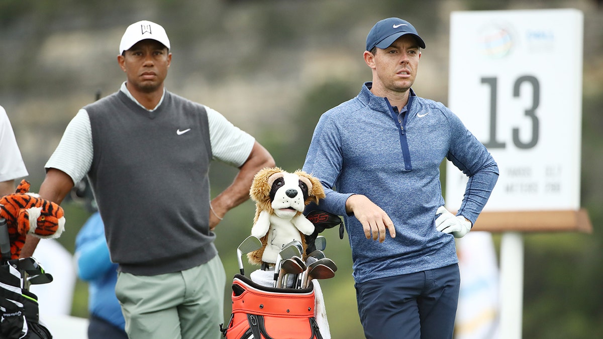 Tiger Woods of the United States and Rory McIlroy of Northern Ireland stand on the 13th tee during the fourth round of the World Golf Championships-Dell Technologies Match Play at Austin Country Club on March 30, 2019 in Austin, Texas.