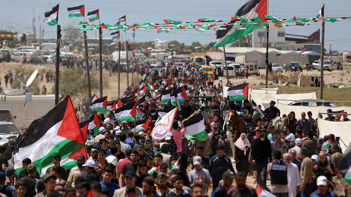 Palestinians attend a protest by the Israeli border with Gaza Strip, Wednesday, May 15, 2019.