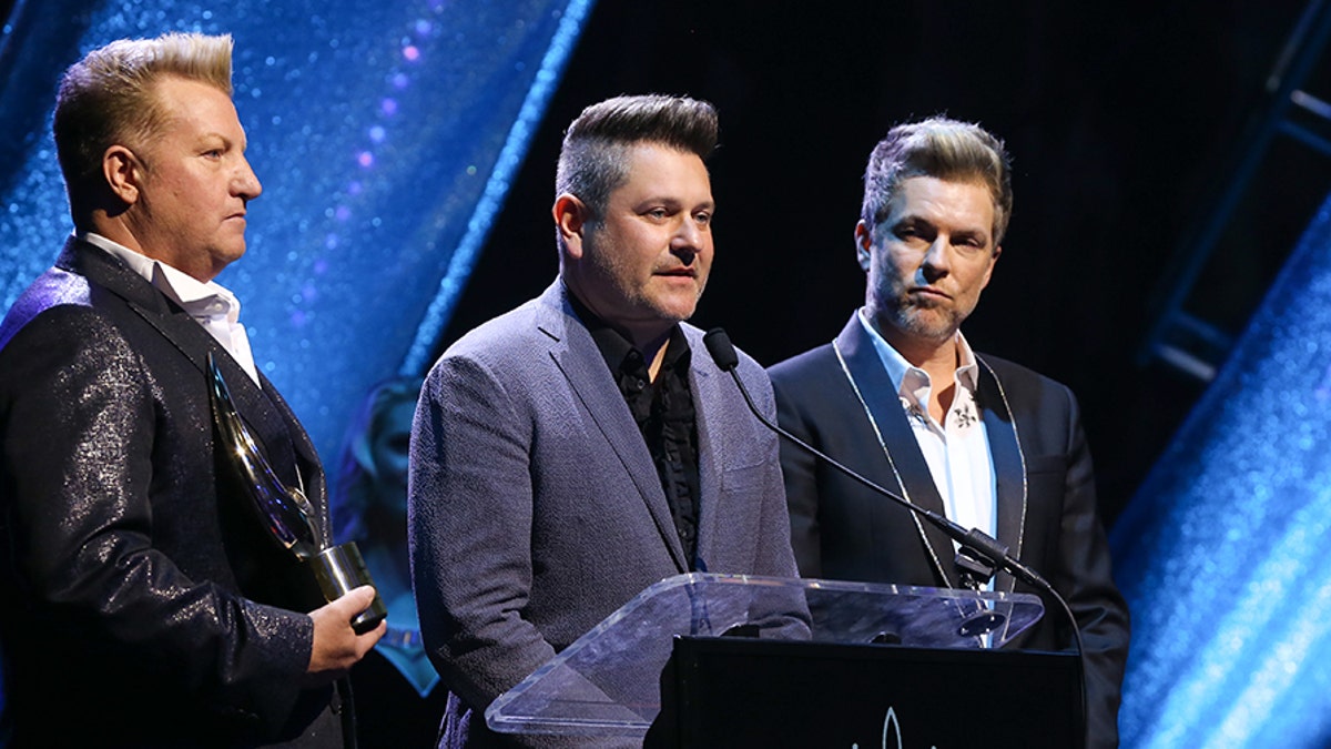 GMA Honorees Gary LeVox, Jay DeMarcus and Joe Don Rooney of Rascal Flatts speak during the 6th Annual GMA Honors and Hall of Fame Ceremony at Allen Arena, Lipscomb University on May 08, 2019 in Nashville, Tenn. (Photo by Terry Wyatt/Getty Images)