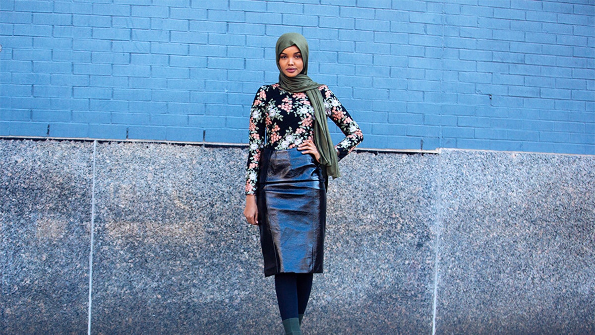 Model Halima Aden wears a green headscarf, black floral top, leather skirt, and green boots on February 8, 2018, in New York City. (Photo by Melodie Jeng/Getty Images)