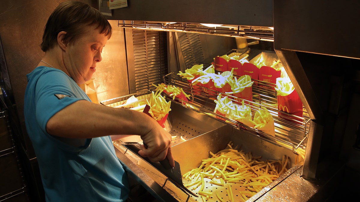 Freia David works the fry station during a retirement celebration.