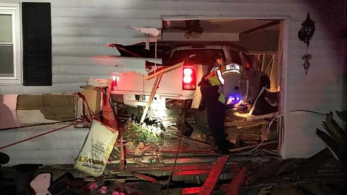 The scene at an Illinois home where a driver rammed their truck into the house.