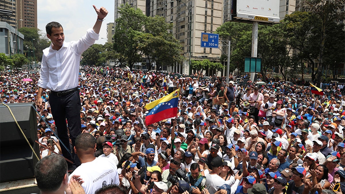 Opposition leader Juan Guaidó flashes a thumbs up at supporters during a rally in Caracas on Wednesday. (AP)