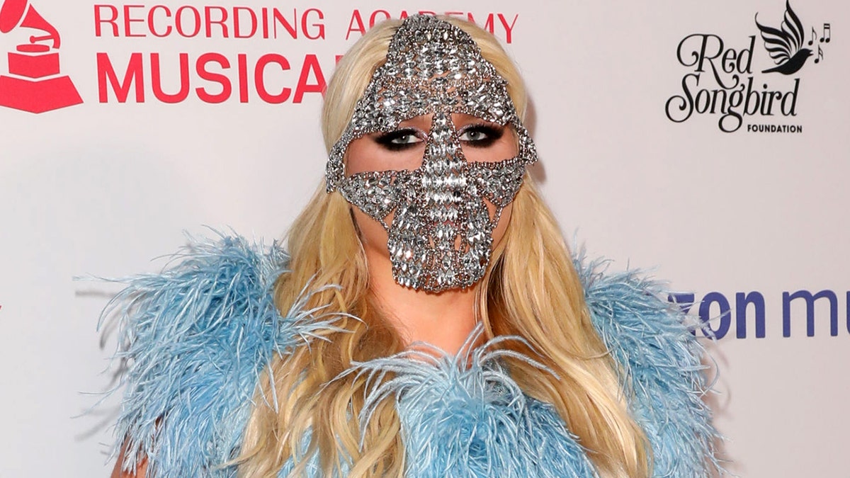 Kesha attended the MusiCares Concert for Recovery on Thursday night wearing a blue sequined gown by designer Cheng-Huai Chuang, with a crystal mask and silver glove for accessories. (Photo by Paul Archuleta/FilmMagic)