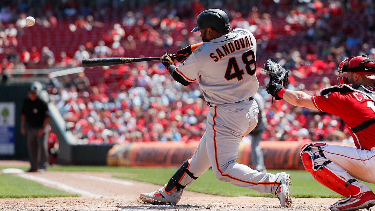 San Francisco Giants' Pablo Sandoval hits a three-run home run off Cincinnati Reds starting pitcher Anthony DeSclafani in the sixth inning of a baseball game, Monday, May 6, 2019, in Cincinnati. (AP Photo/John Minchillo)