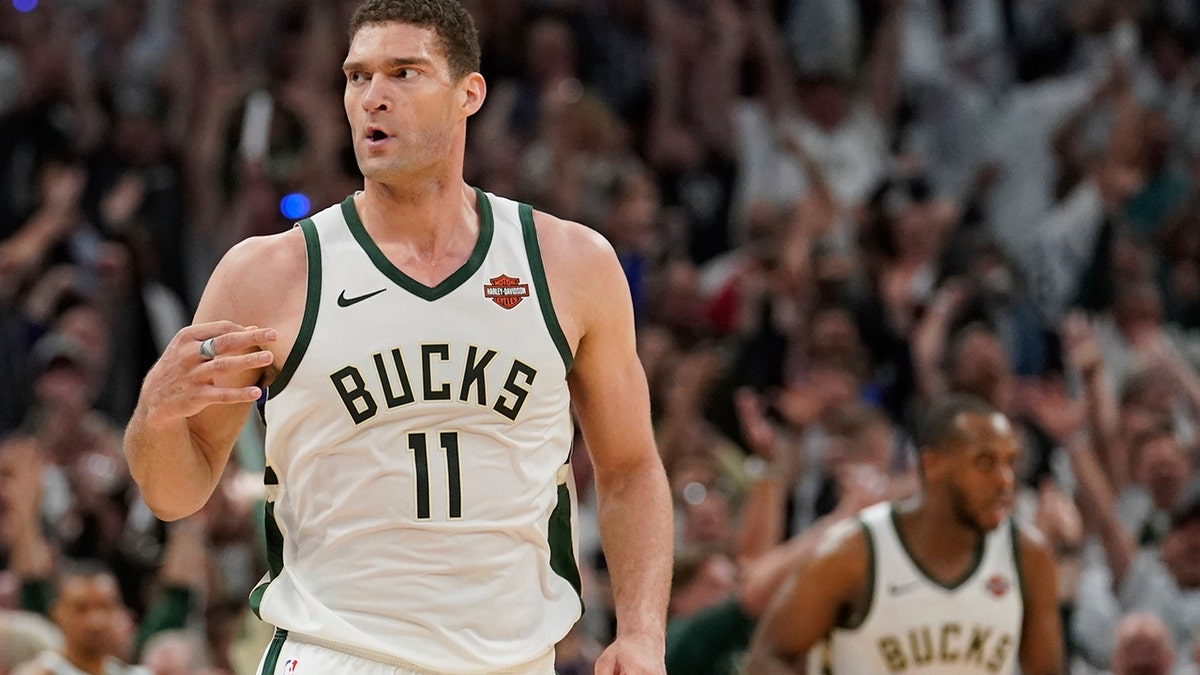 Milwaukee Bucks' Brook Lopez reacts to his three-point basket during the second half of Game 1 of the NBA Eastern Conference basketball playoff finals against the Toronto Raptors Wednesday, May 15, 2019, in Milwaukee. The Bucks won 108-100 to take a 1-0 lead in the series. (AP Photo/Morry Gash)