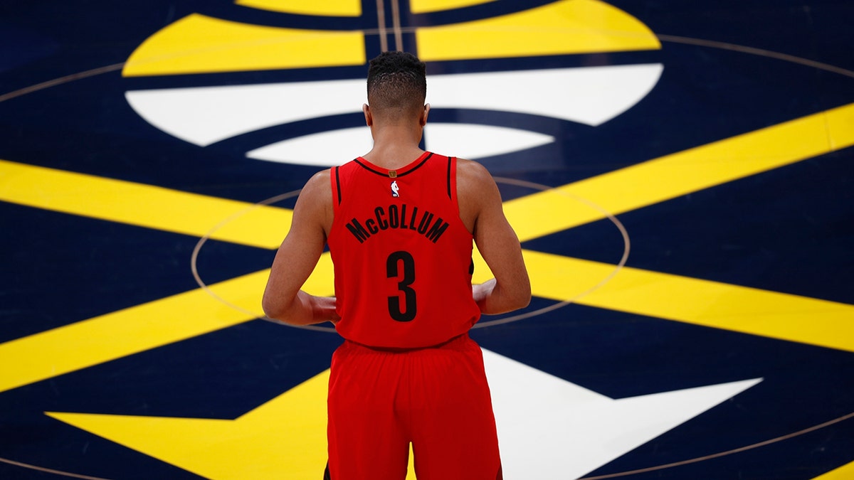Portland Trail Blazers guard CJ McCollum stands at center court waiting for the start of the first half of Game 7 of an NBA basketball second-round playoff series against the Denver Nuggets Sunday, May 12, 2019, in Denver. (AP Photo/David Zalubowski)