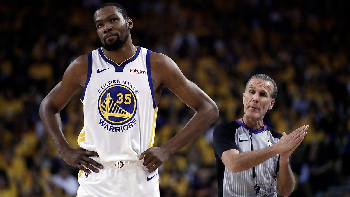 Golden State Warriors' Kevin Durant, left, walks away from referee Ken Mauer during the first half of Game 5 of the team's second-round NBA basketball playoff series against the Houston Rockets on Wednesday, May 8, 2019, in Oakland, Calif. (AP Photo/Ben Margot)