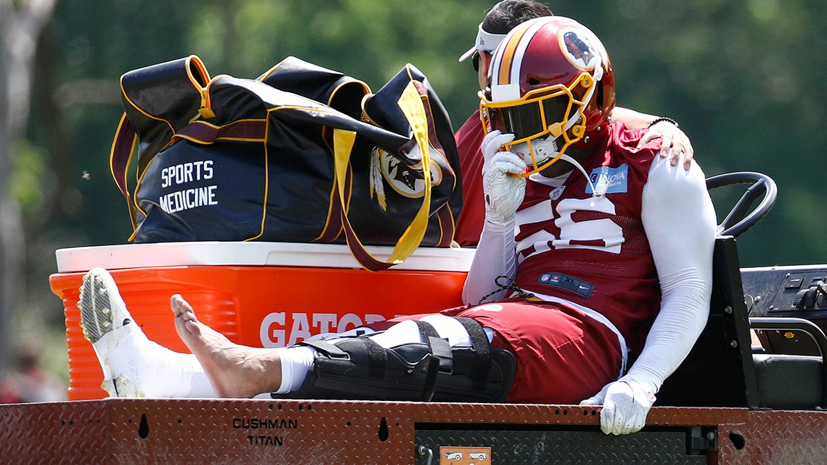 Washington Redskins linebacker Reuben Foster rides a cart off the field after suffering an injury during a practice at the team's NFL football practice facility. (AP Photo/Patrick Semansky)
