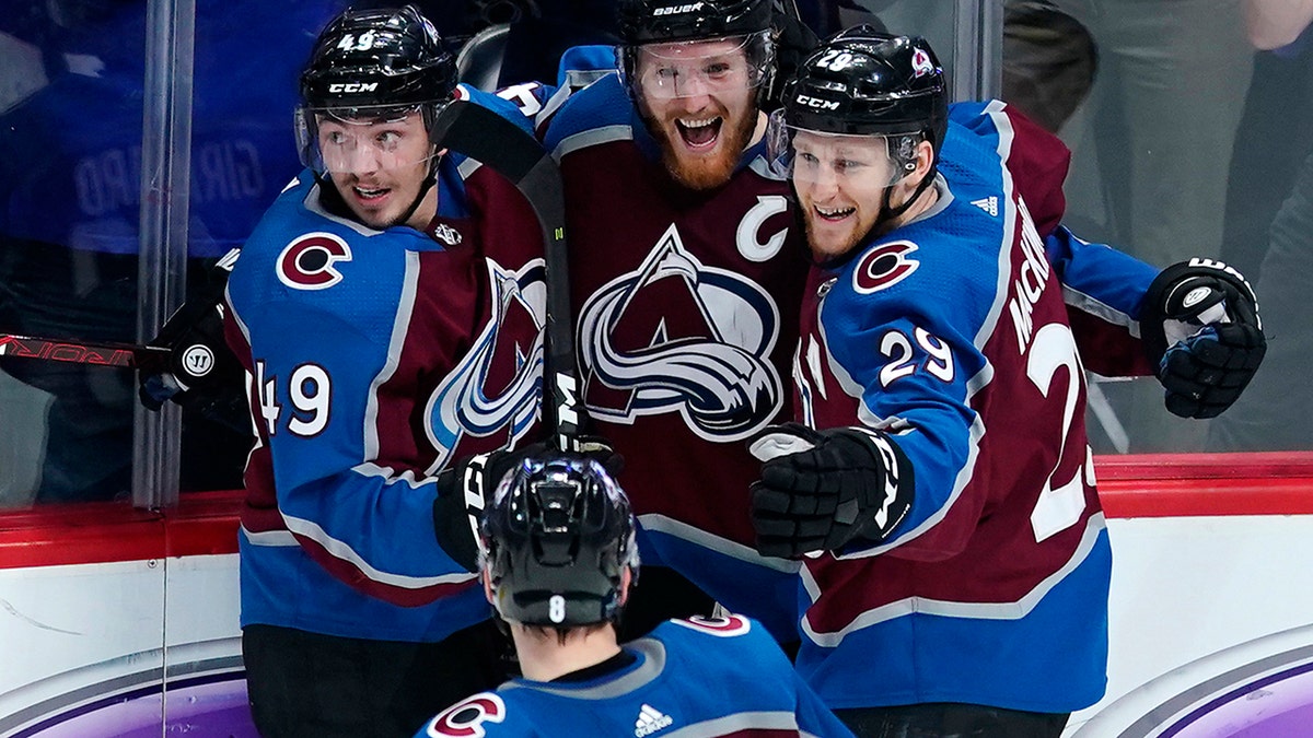 Colorado Avalanche left wing Gabriel Landeskog (92) is congratulated by teammates Samuel Girard (49), Nathan MacKinnon (29) and Cale Makar (8) after scoring a game-winning, overtime goal against the San Jose Sharks in Game 6 of an NHL hockey second-round playoff series, Monday, May 6, 2019, in Denver. Colorado won 4-3 in overtime. (AP Photo/Jack Dempsey)