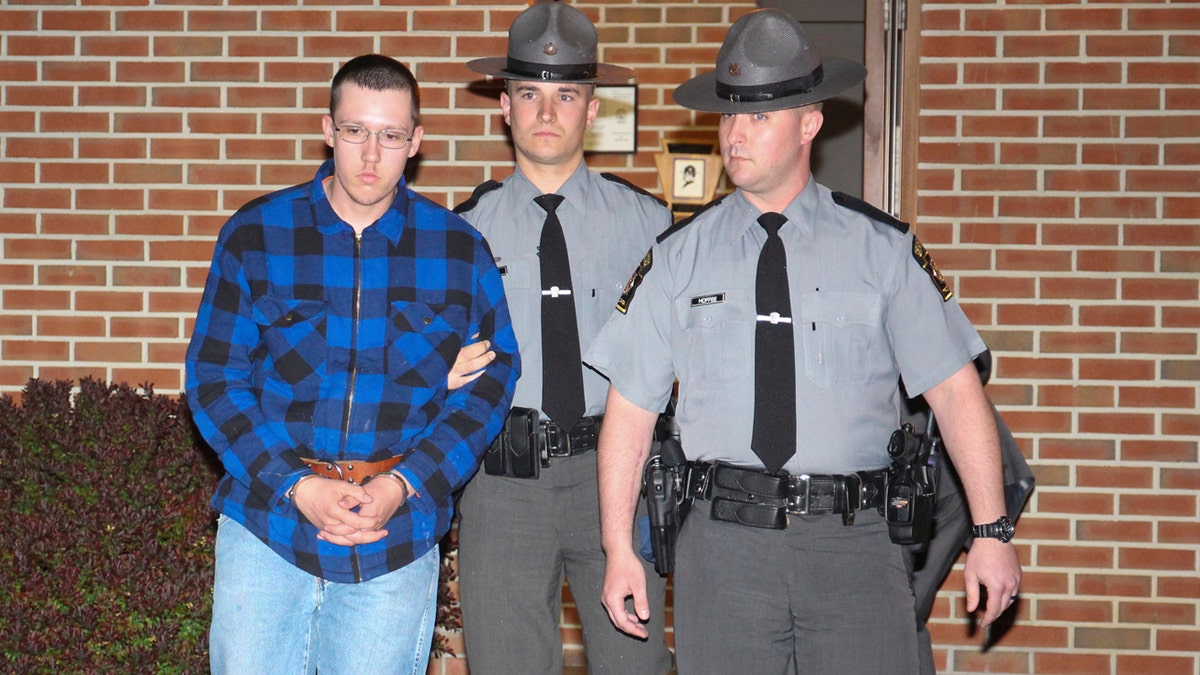 Thomas Dewald is escorted by Pennsylvania State troopers Monday night, April 29, 2019 after being charged in two recent cases in the Rouzerville, Pa. area.