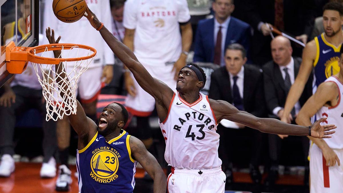 Toronto Raptors forward Pascal Siakam (43) blocks a shot by Golden State Warriors forward Draymond Green (23) during the second half of Game 1 of basketball’s NBA Finals, Thursday, May 30, 2019, in Toronto. (Associated Press)
