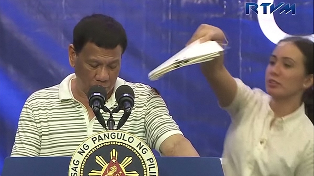 A female aide quickly intervened to save President Duterte from the awkward moment, but her efforts to remove the cockroach failed, prompting the insect to run down the front of the president’s shirt.