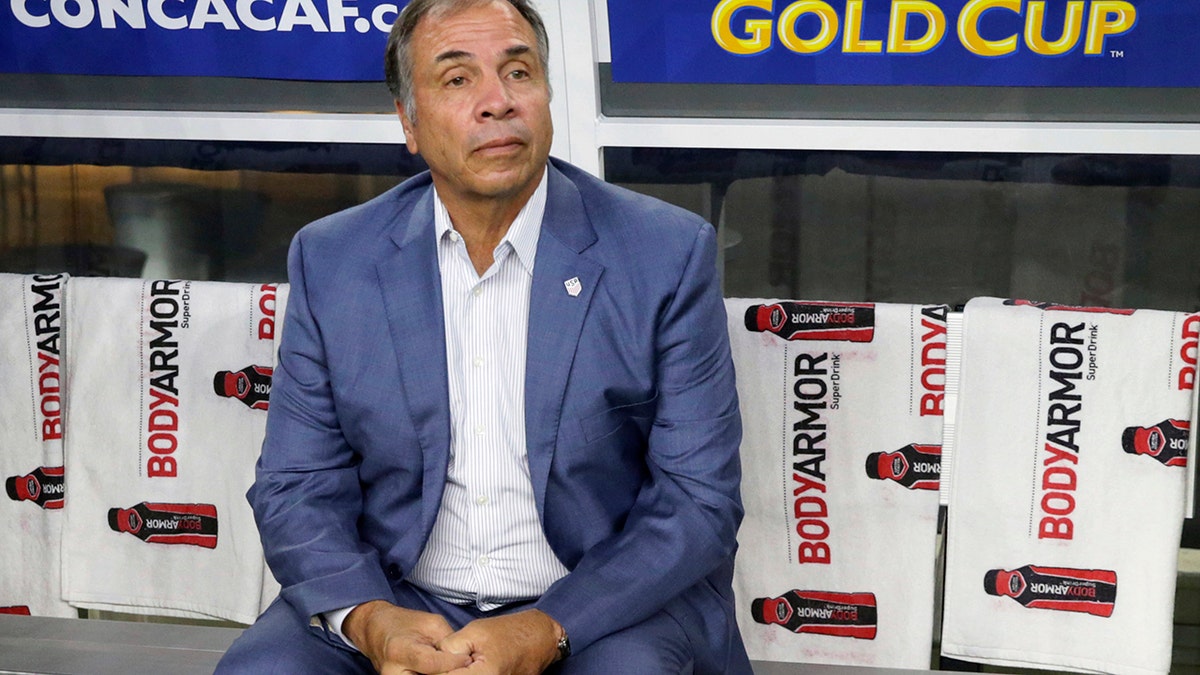 FILE - In this July 22, 2017, file photo, United States head coach Bruce Arena sits on the bench prior to a CONCACAF Gold Cup semifinal soccer match against Costa Rica, in Arlington, Texas. The New England Revolution have hired five-time MLS Cup winner and former U.S. national coach Bruce Arena as its coach and sports director. (AP Photo/LM Otero, File)