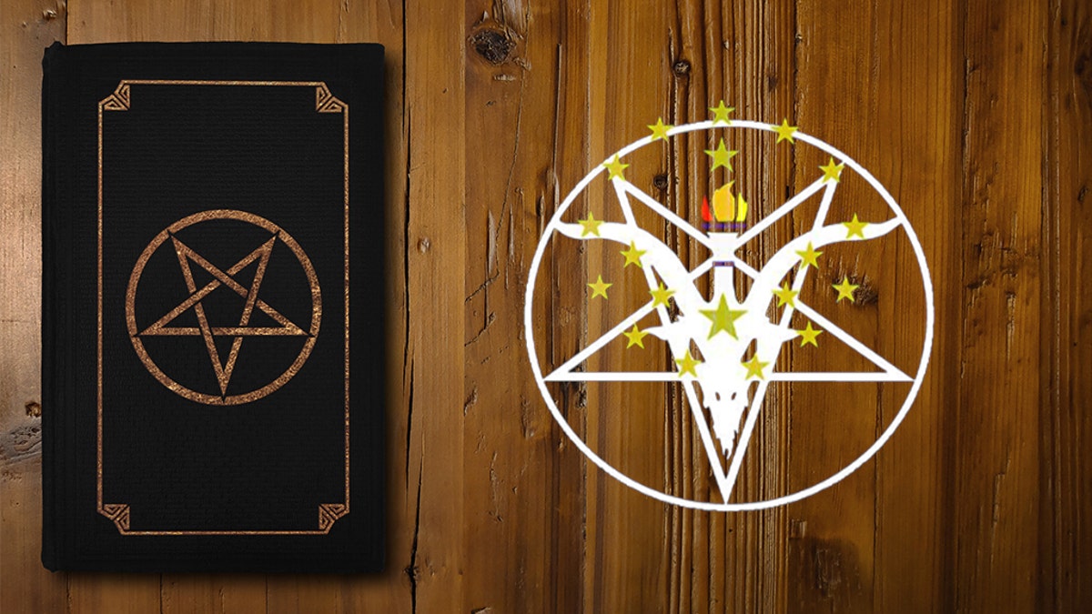 Close-up on a black book with a gilded Reverse Pentagram on a brown board.