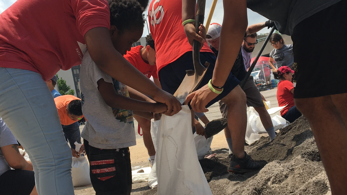 Four-year-old Jeremiah helps load sandbags in Fort Smith