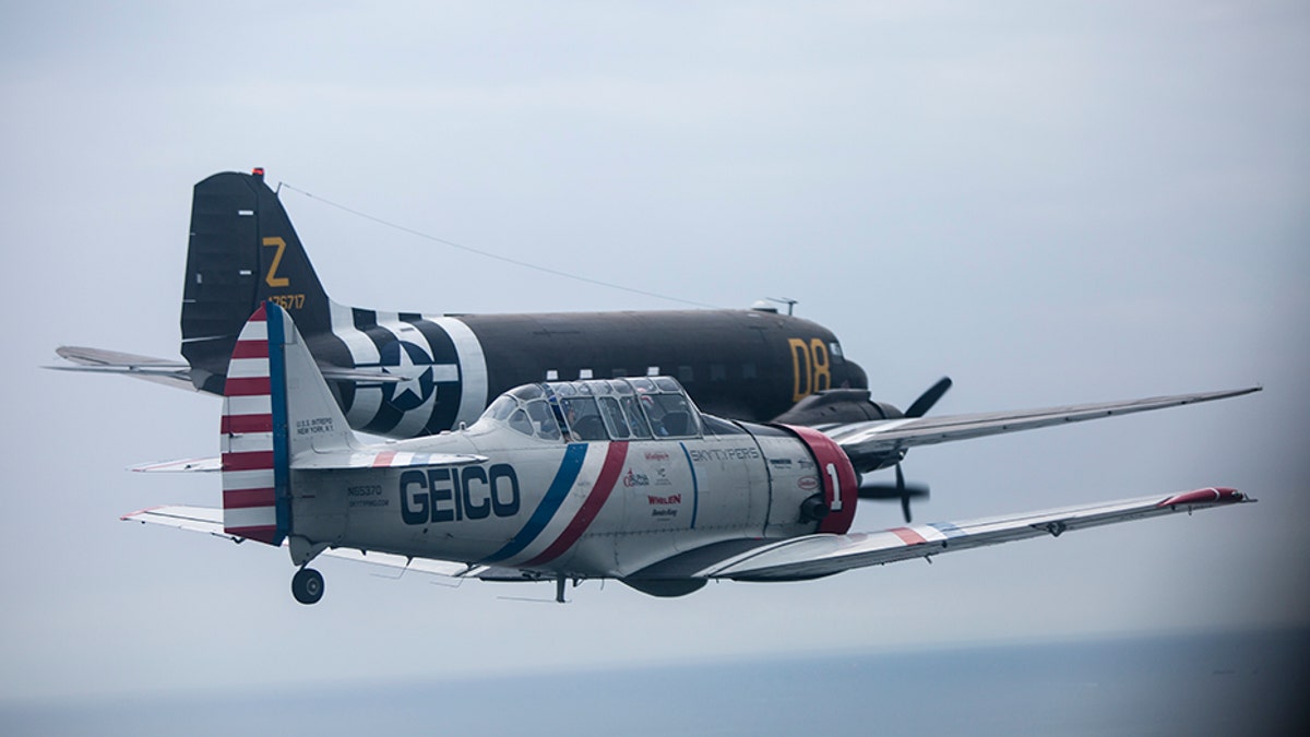 During a symbolic flight hosted by the American Airpower Museum on Long Island, the Skytypers flew by the Statue of Liberty alongside a Douglas C-47 -- a military transport aircraft used to deploy paratroopers during D-Day.