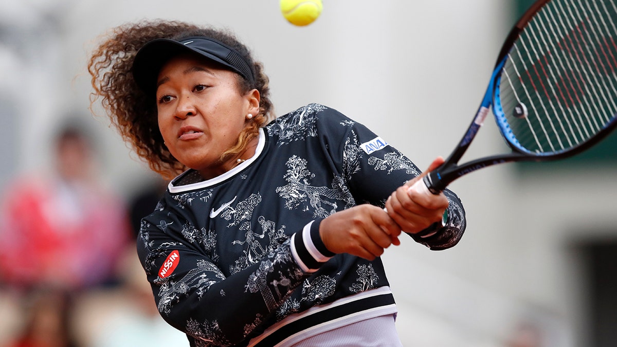 Japan's Naomi Osaka plays a shot against Slovakia's Anna Karolina Schmiedlova during their first round match of the French Open tennis tournament at the Roland Garros stadium in Paris, Tuesday, May 28, 2019. (AP Photo/Christophe Ena )