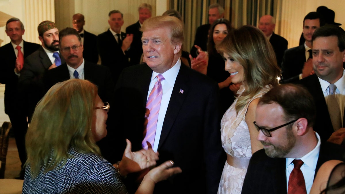 President Donald Trump joined by first lady Melania Trump arrive to attend a National Day of Prayer dinner gathering of faith leaders from the interfaith community in the State Dining Room of the White House in Washington, Wednesday, May 1, 2019. (AP Photo/Manuel Balce Ceneta)