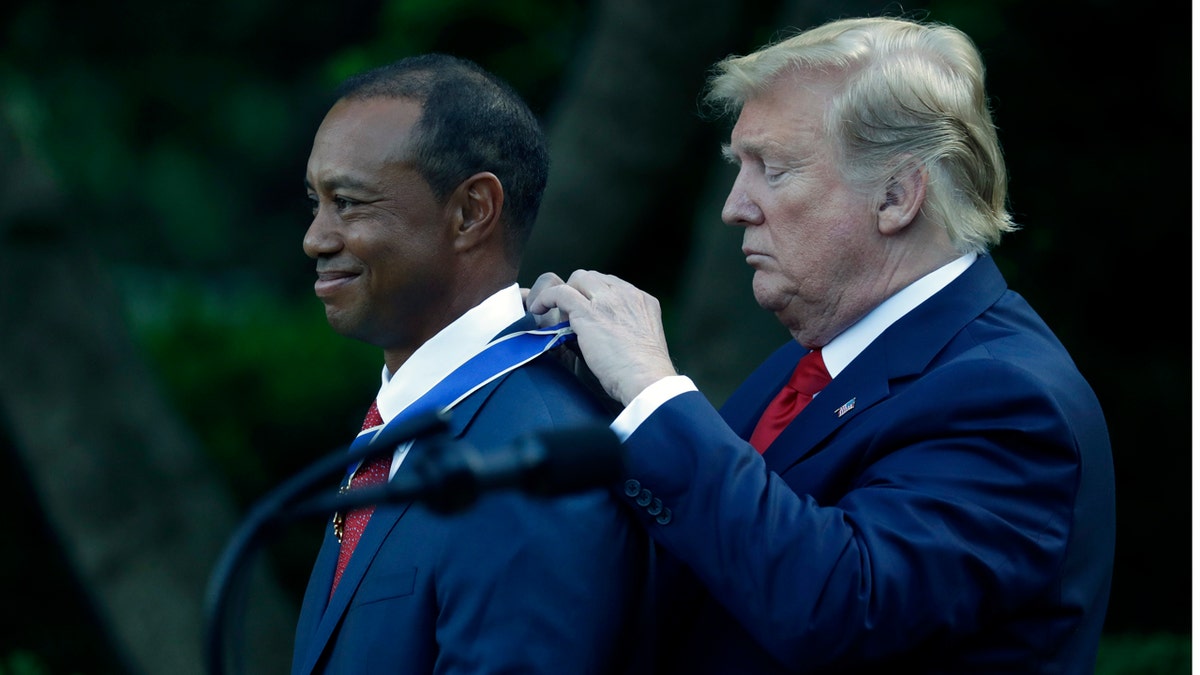 President Trump presents Tiger Woods with the Presidential Medal of Freedom in the White House Rose Garden. (AP Photo/Evan Vucci)