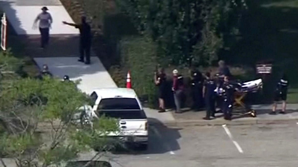 Police evacuate people from a building as a stretcher stands by in this still image taken from video following a shooting incident at the municipal center in Virginia Beach, Virginia, U.S. May 31, 2019.?