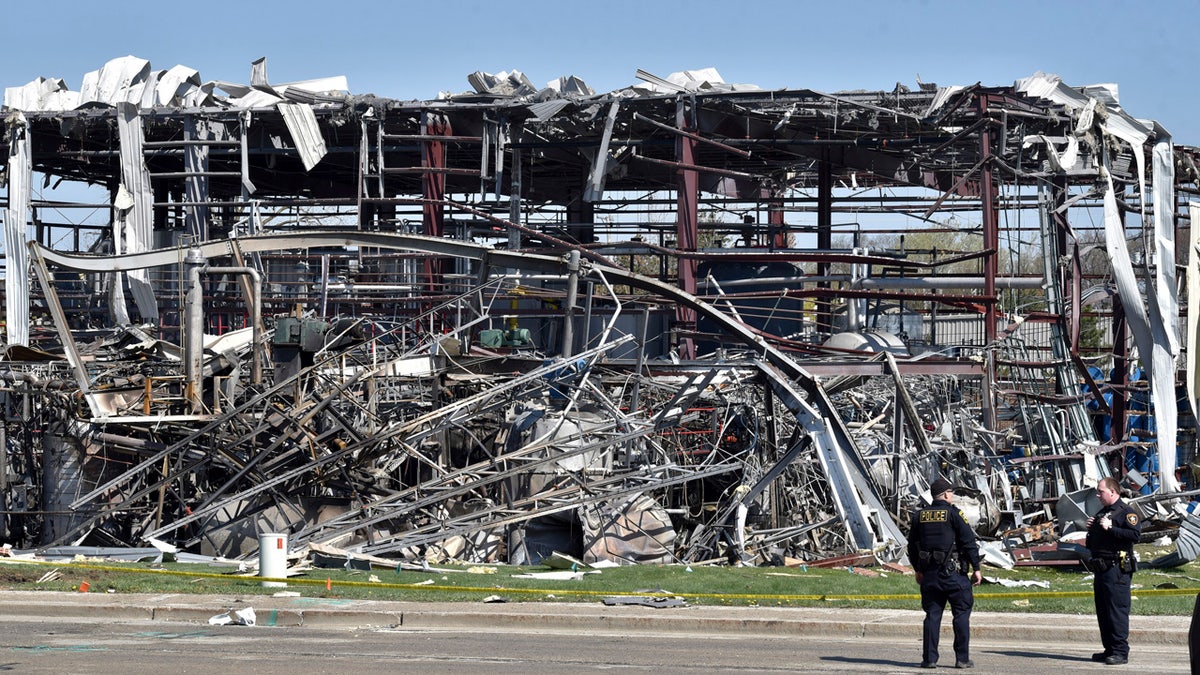 Emergency personnel work at the scene of an explosion at AB Specialty Silicones on Sunset and Northwestern Avenues on the border between Gurnee, Ill., and Waukegan on Saturday. The explosion happened Friday night. (John Starks/Daily Herald via AP)