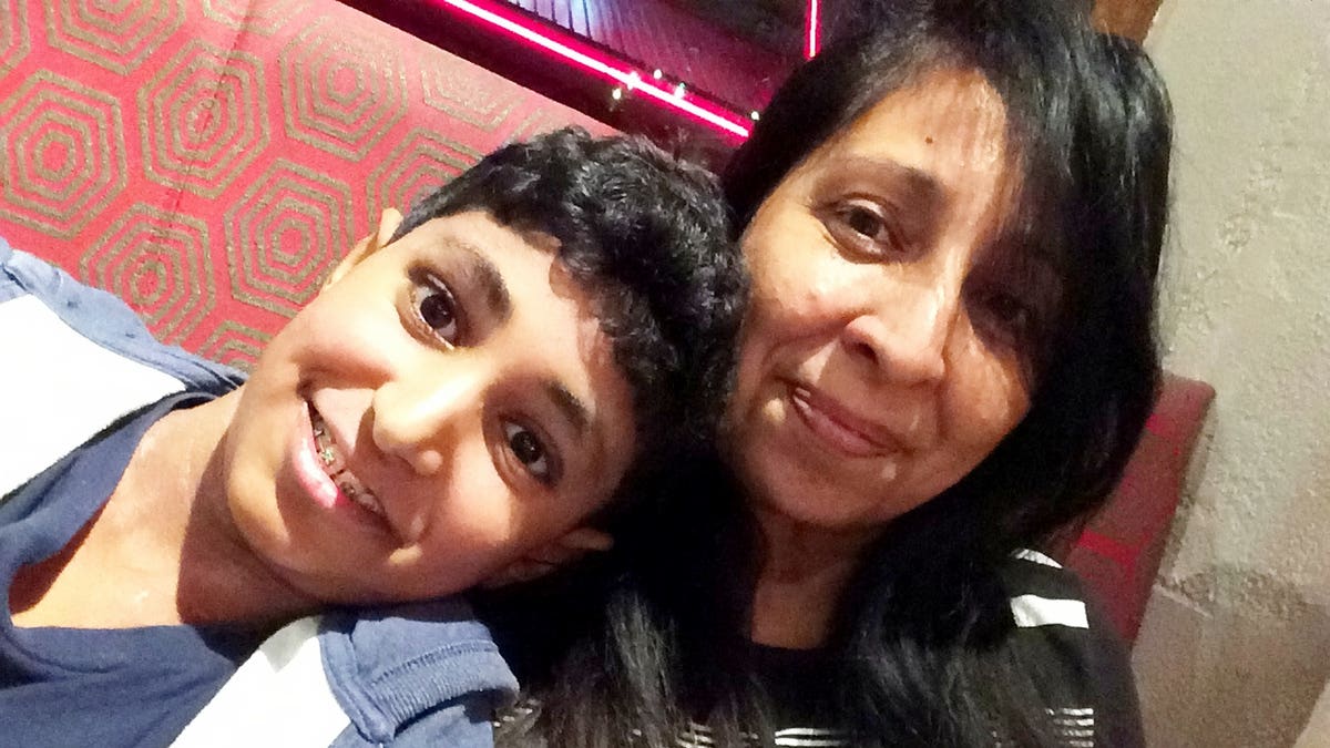 Karan, pictured with his mom, was given an expired EpiPen due to a spreadsheet error, the court heard Thursday.