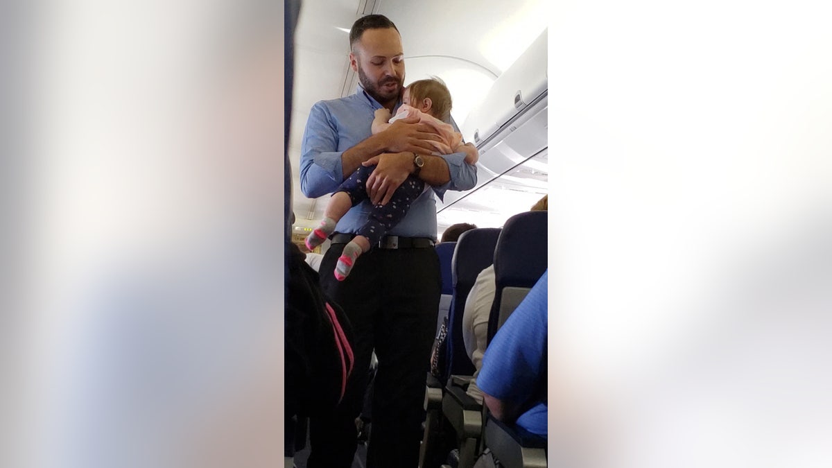 Southwest staffer Wesley Hunt, pictured, said that comforting baby Alayna was simply the right thing to do.