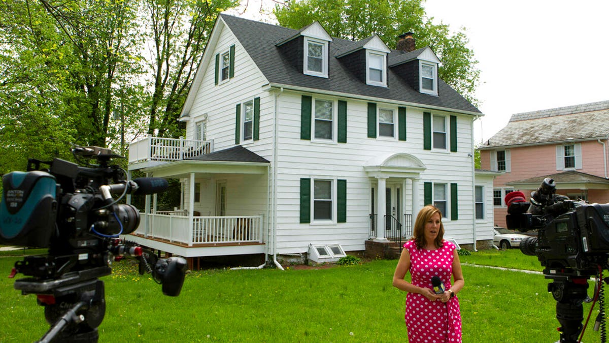 TV crews report form outside the house of Baltimore Mayor Catherine Pugh in Baltimore, MD., Thursday, April 25, 2019.