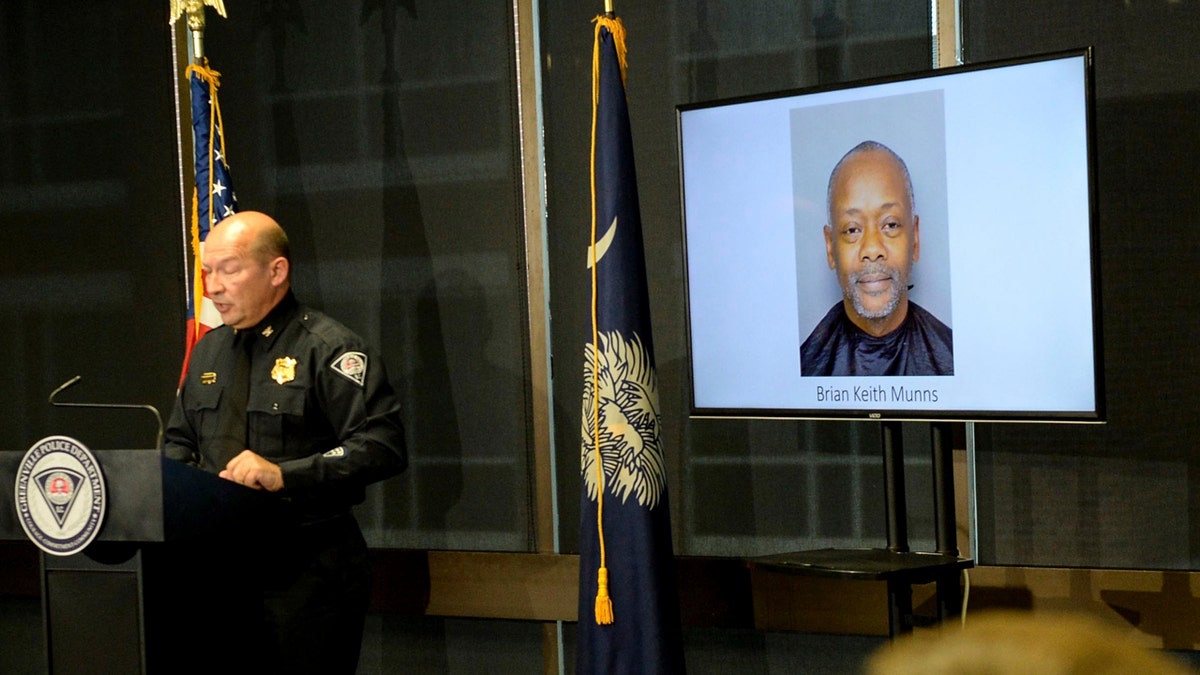 A Greenville police photo of arrested suspect Brian Keith Munns is displayed as police chief Ken Miller talks about an arrest in the 1988 cold case homicide of Alice Haynesworth Ryan.