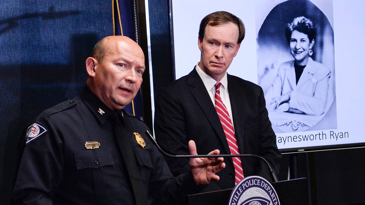 Greenville police Chief Ken Miller, left, talks near Thirteenth Circuit Solicitor Walt Wilkins, right, about an arrest in the 1988 cold case homicide of Alice Haynesworth Ryan.