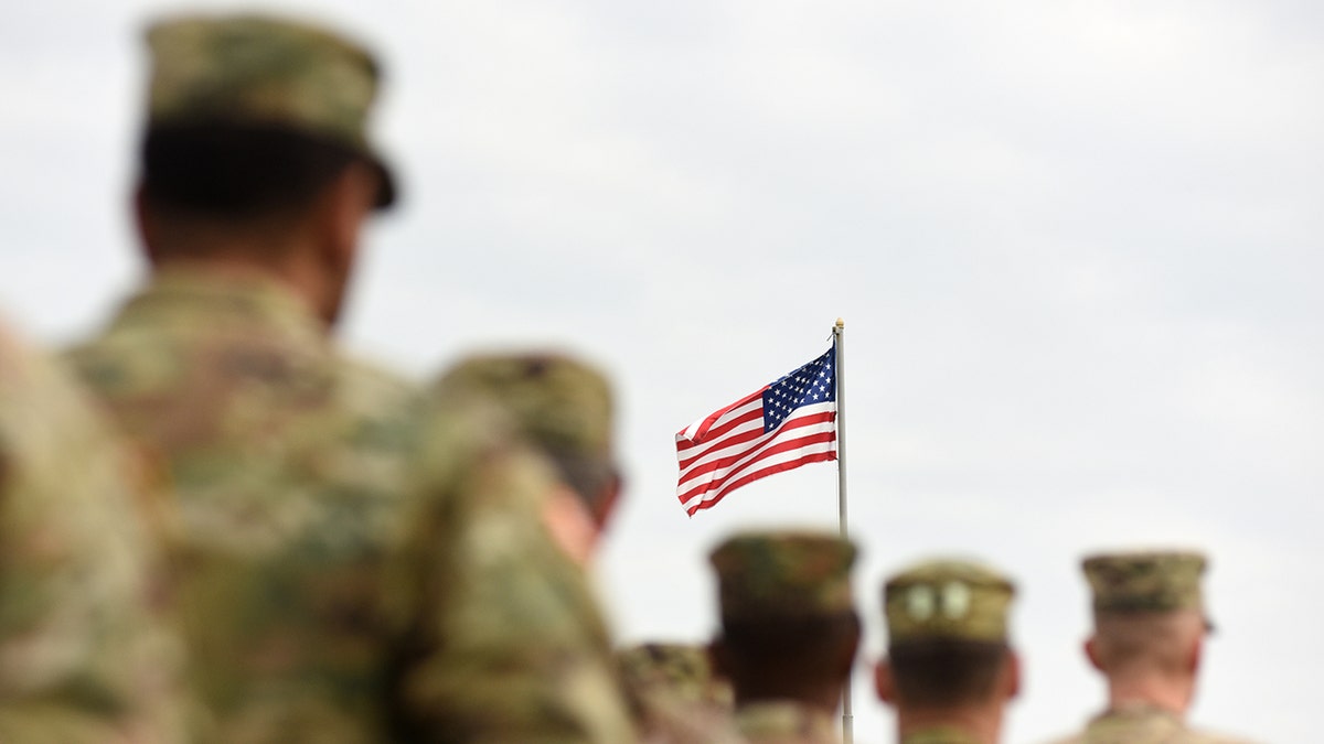 US soldiers and an American flag