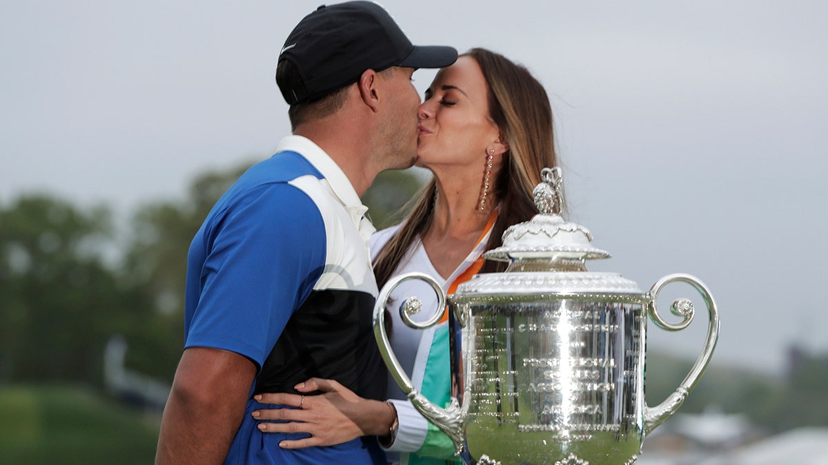 Brooks Koepka, left, kisses his girlfriend Jena Sims after winning the PGA Championship golf tournament. (AP)