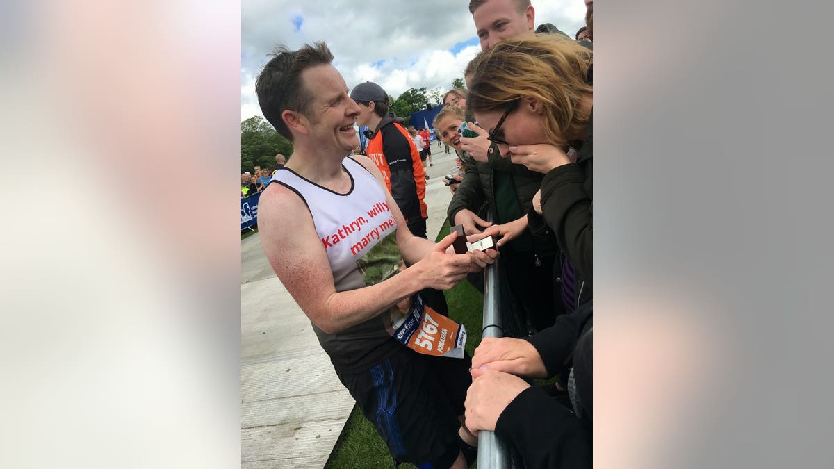 The emotional moment that marathon runner Jonny Black, 43, proposed to partner Kathryn Keir, 41, at the end of this weekend's Edinburgh Marathon.