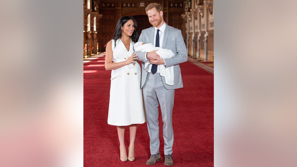 Britain's Prince Harry, Duke of Sussex (R), and his wife Meghan, Duchess of Sussex, pose for a photo with their newborn baby son in St George's Hall at Windsor Castle in Windsor, west of London on May 8, 2019. (Photo by Dominic Lipinski / POOL / AFP) (Photo credit should read DOMINIC LIPINSKI/AFP/Getty Images)