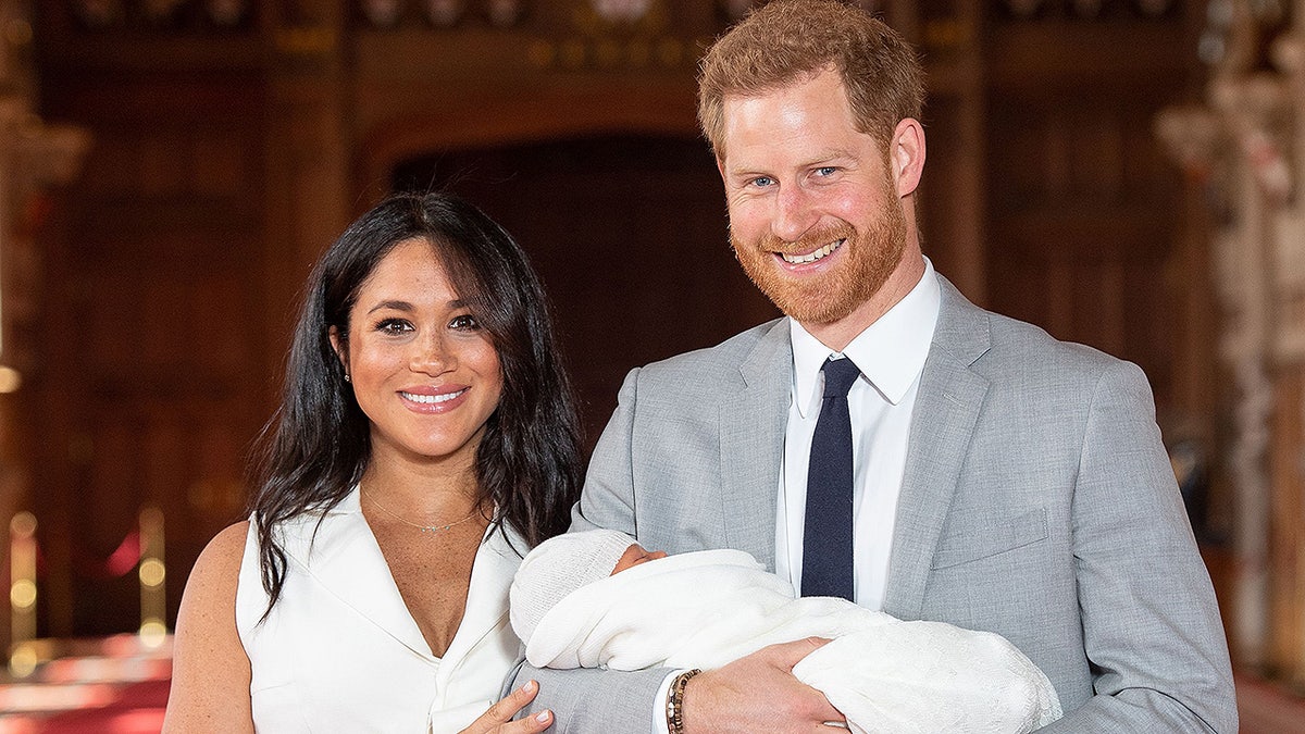 Britain's Prince Harry, Duke of Sussex (R), and his wife Meghan, Duchess of Sussex, pose for a photo with their newborn baby son in St George's Hall at Windsor Castle in Windsor, west of London on May 8, 2019. (Photo by Dominic Lipinski / POOL / AFP) (Photo credit should read DOMINIC LIPINSKI/AFP/Getty Images)